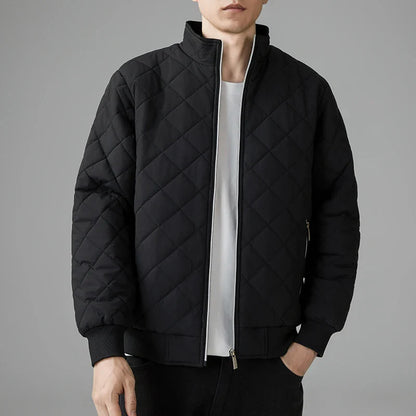 Men's black padded quilted jacket with zipper closure, sleek modern silhouette and lightweight insulation