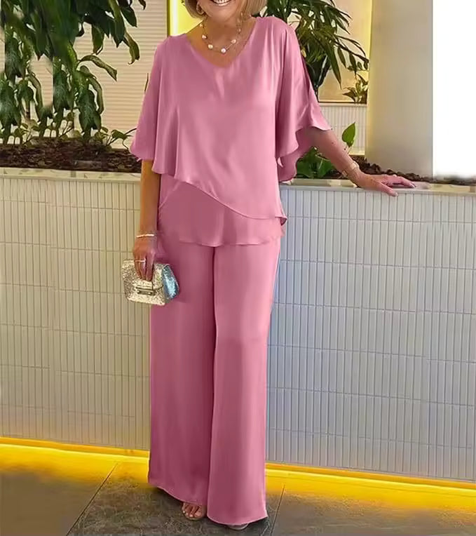 Elegant two-piece matching set with flowing top and wide-leg pants in a polished chic style