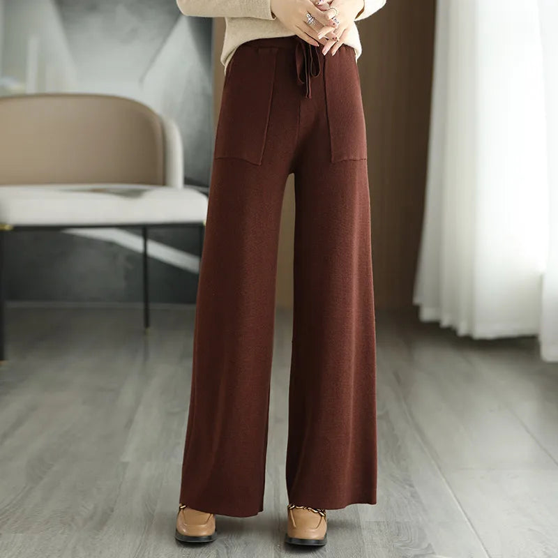 High waisted wide-leg wool pants in neutral tone with relaxed silhouette and flattering waistband