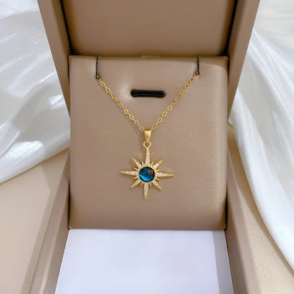 Gold-plated celestial necklace with aquamarine gemstone and dainty crystal accents on cable chain