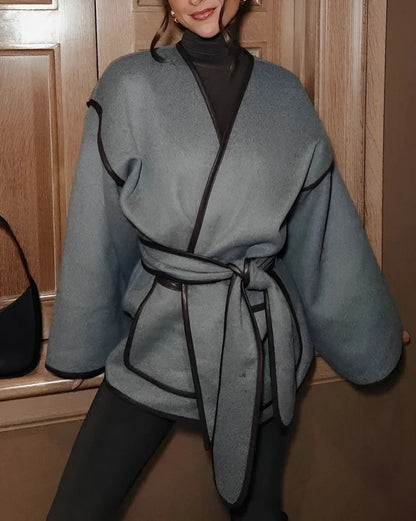 Women's oversized striped lace overcoat with leather trim accents, drop shoulders, and flared sleeves
