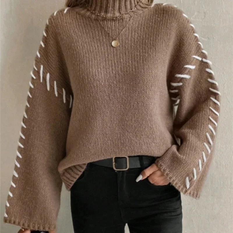 Carmine red soft-knit pullover sweater with relaxed high neck and contrast sleeve stitching
