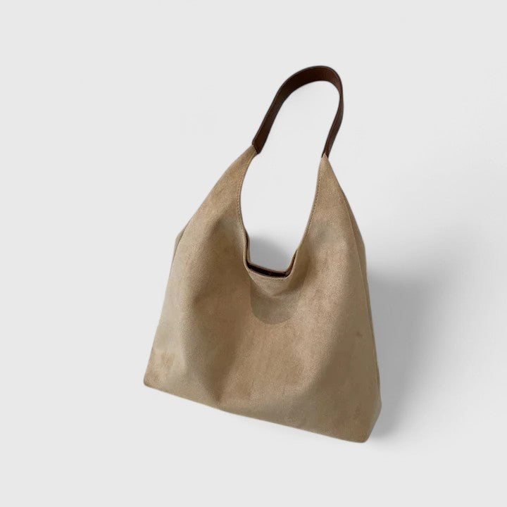 Minimalist white shoulder bag with clean lines, structured silhouette, and single strap everyday design