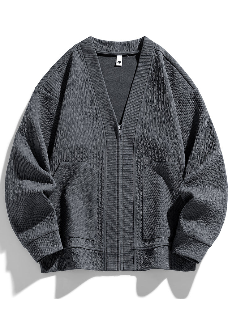 Oversized zip-up cardigan in textured cotton blend with relaxed drape and sleek zipper closure