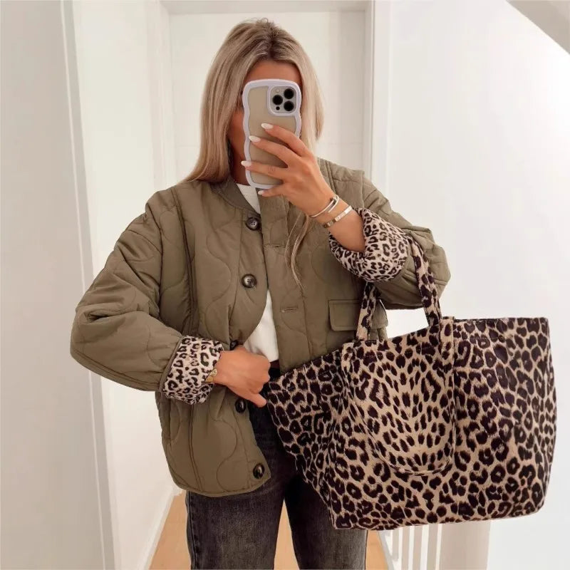 Black padded cotton jacket with leopard patchwork sleeves, quilted silhouette, street-ready style
