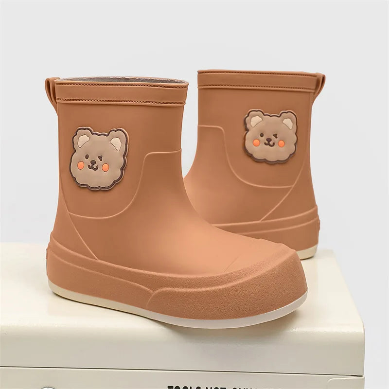 Women's black rubber ankle rain boots with playful bear motif pull-on silhouette for wet weather
