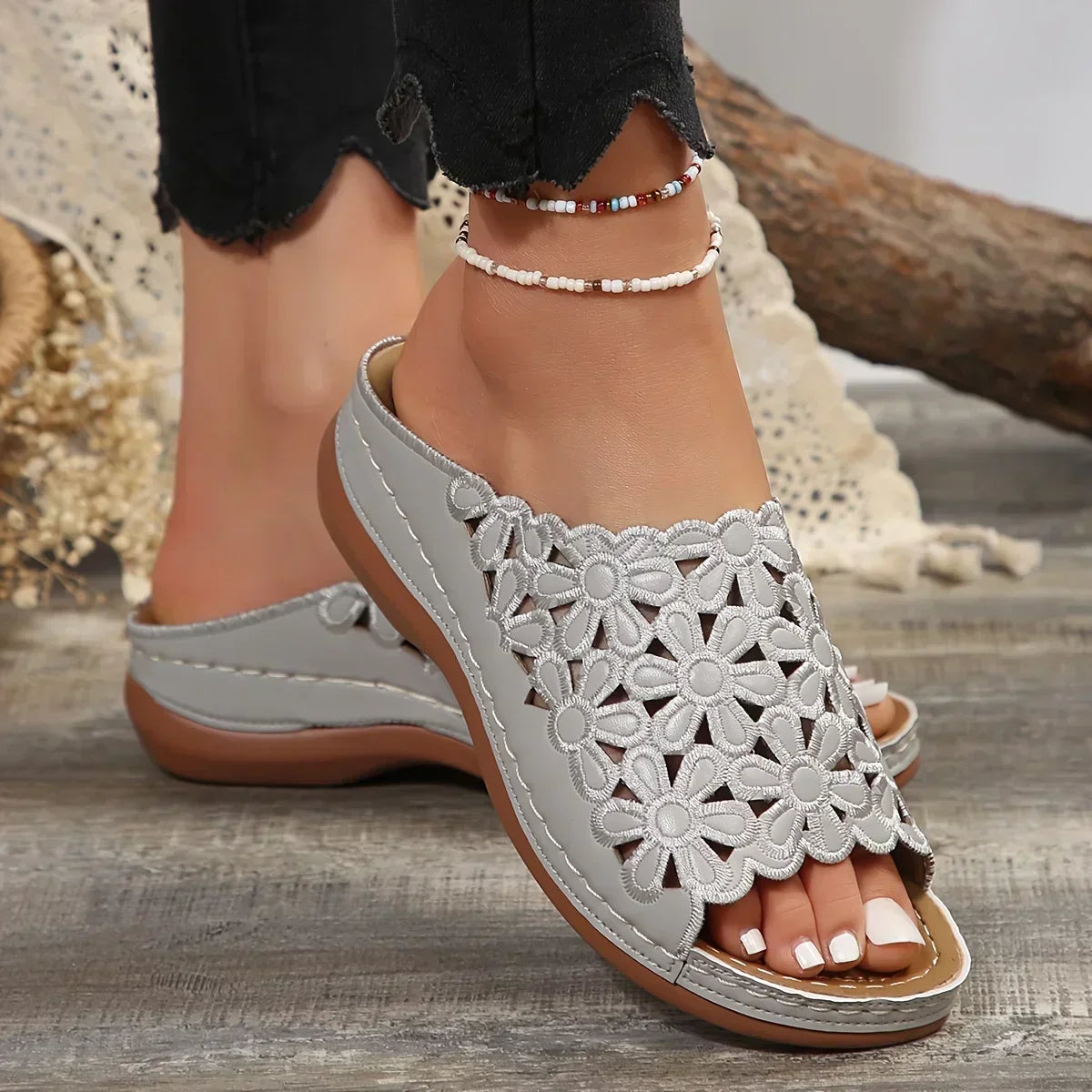 Women's floral comfort sandals with delicate flower accents and cushioned insole for all-day support