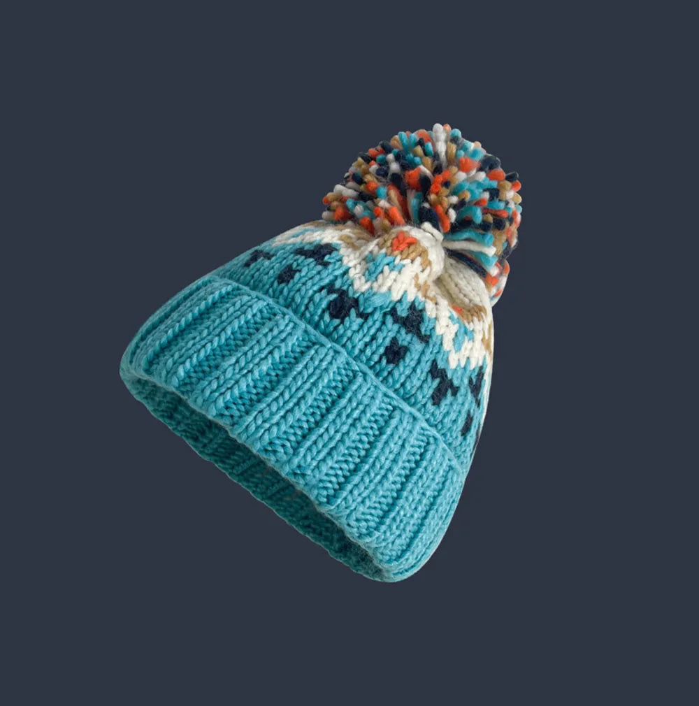 Cozy knit beanie with snowflake pattern and fluffy pom, festive winter style for women