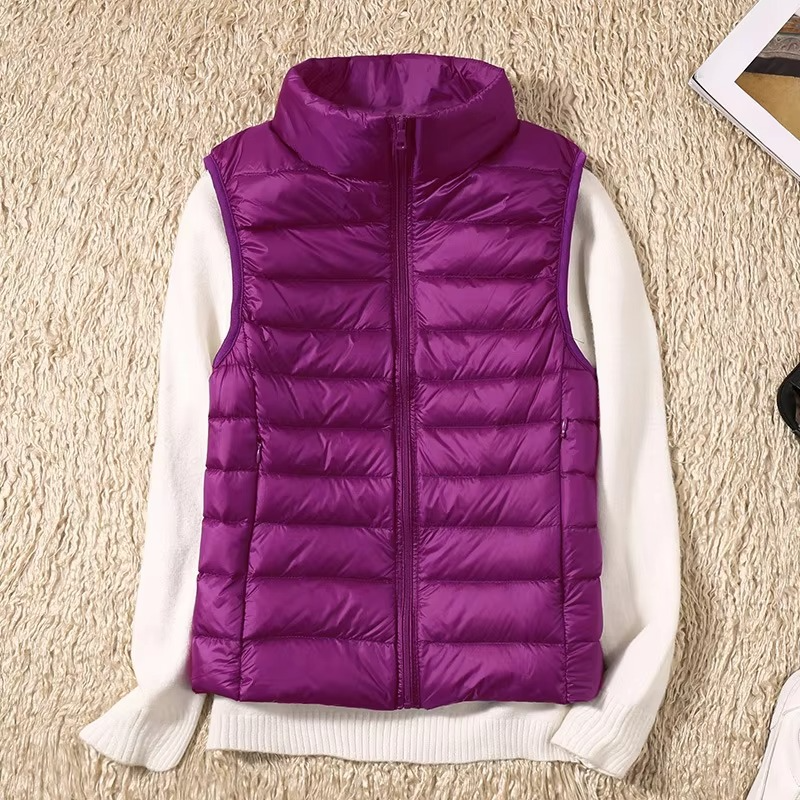 Women's cropped sleeveless light down puffer vest in neutral tone, slim-fit silhouette with quilted panels