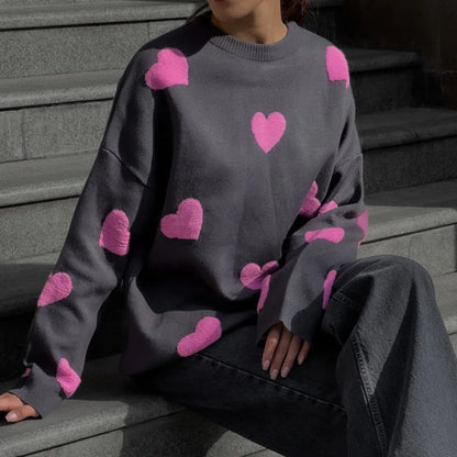 Soft pink women's heart print sweater with delicate embroidered accents and feminine relaxed fit