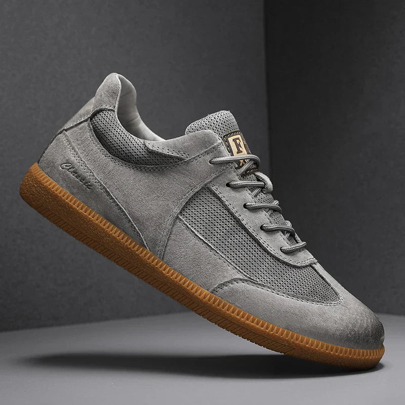 Men's white faux leather low-profile lace-up sneaker with distinctive gum sole casual style