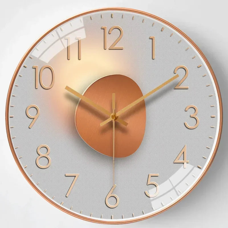Golden tone glass and metal wall clock with minimalist hour markers and gradient circular face