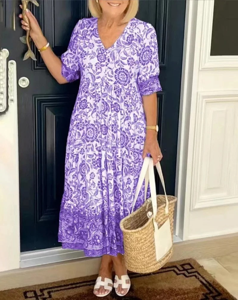 Elegant floral midi dress with V-neck, flowing silhouette and romantic spring print