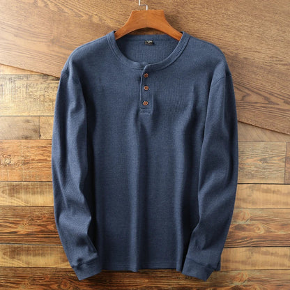 Beige waffle knit Henley long sleeve shirt with minimalist design and double-stitched details