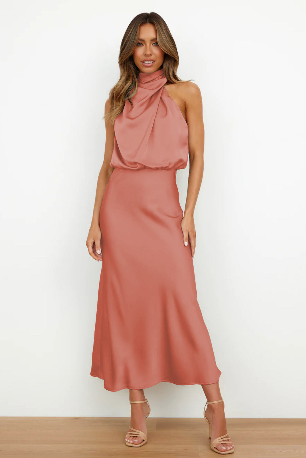 Elegant black satin halter evening dress with flowing silhouette and sleek finish