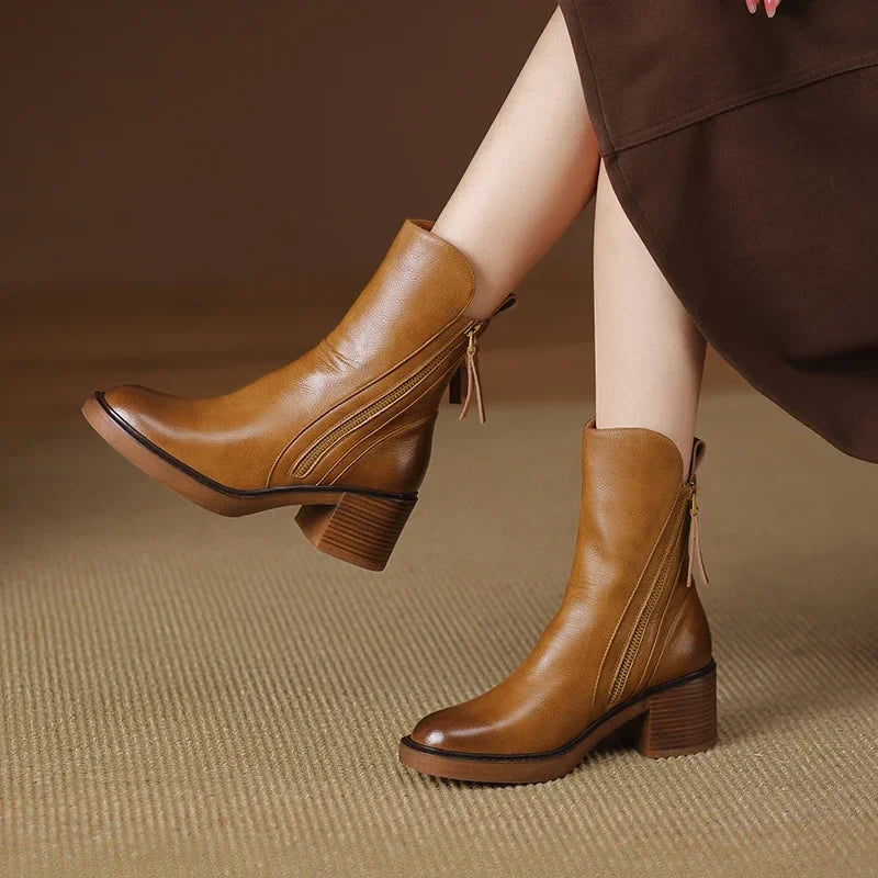 Black ankle-height orthopedic boots with sleek streamlined silhouette and advanced arch support