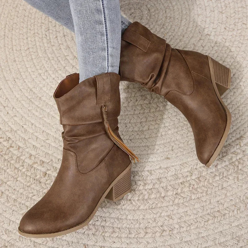 Brown mid-calf Western cowboy boots with classic stitching detailing and curved silhouette