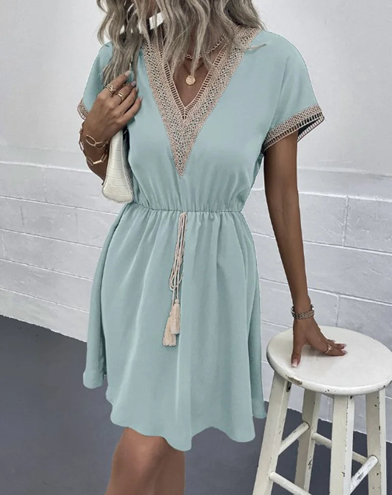 Women's boho flowy draped dress with elegant V-neckline, waist-defining tie, casual chic silhouette