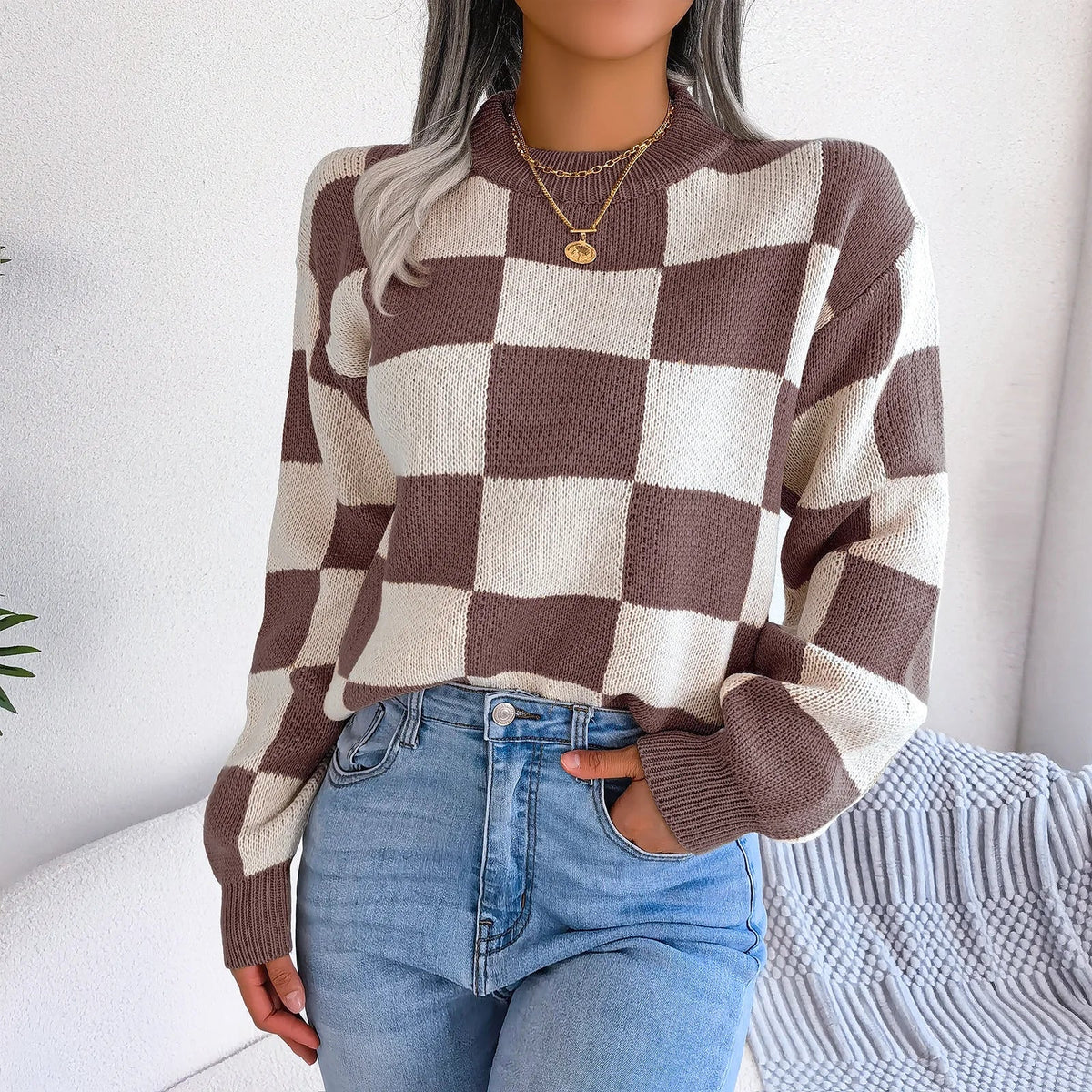 Relaxed checkered knit sweater in warm beige and ivory tones with bold vintage-inspired pattern