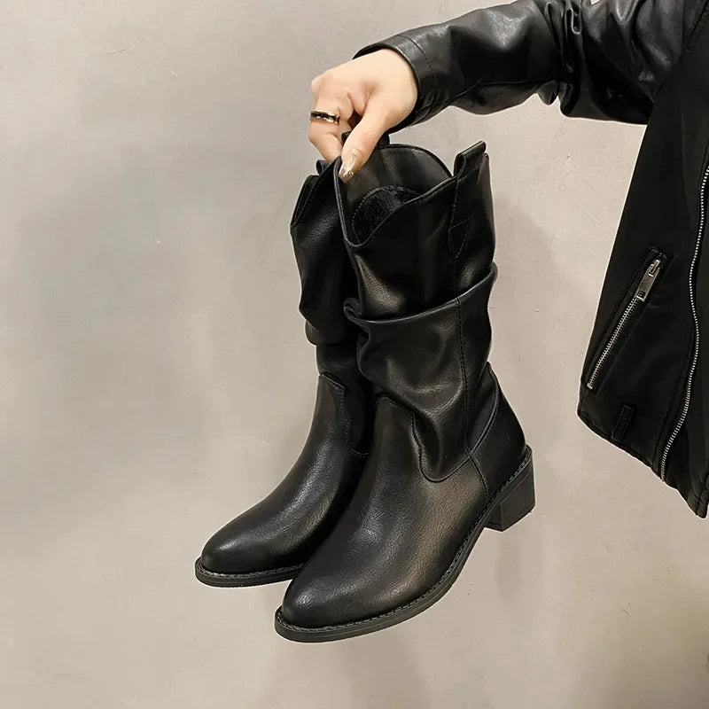 Women's brown leather knee-high slouch boots with low heel, relaxed shaft silhouette