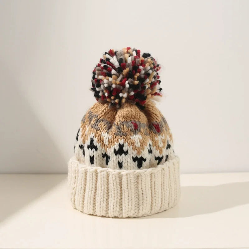 Cozy knit beanie with snowflake pattern and fluffy pom, festive winter style for women