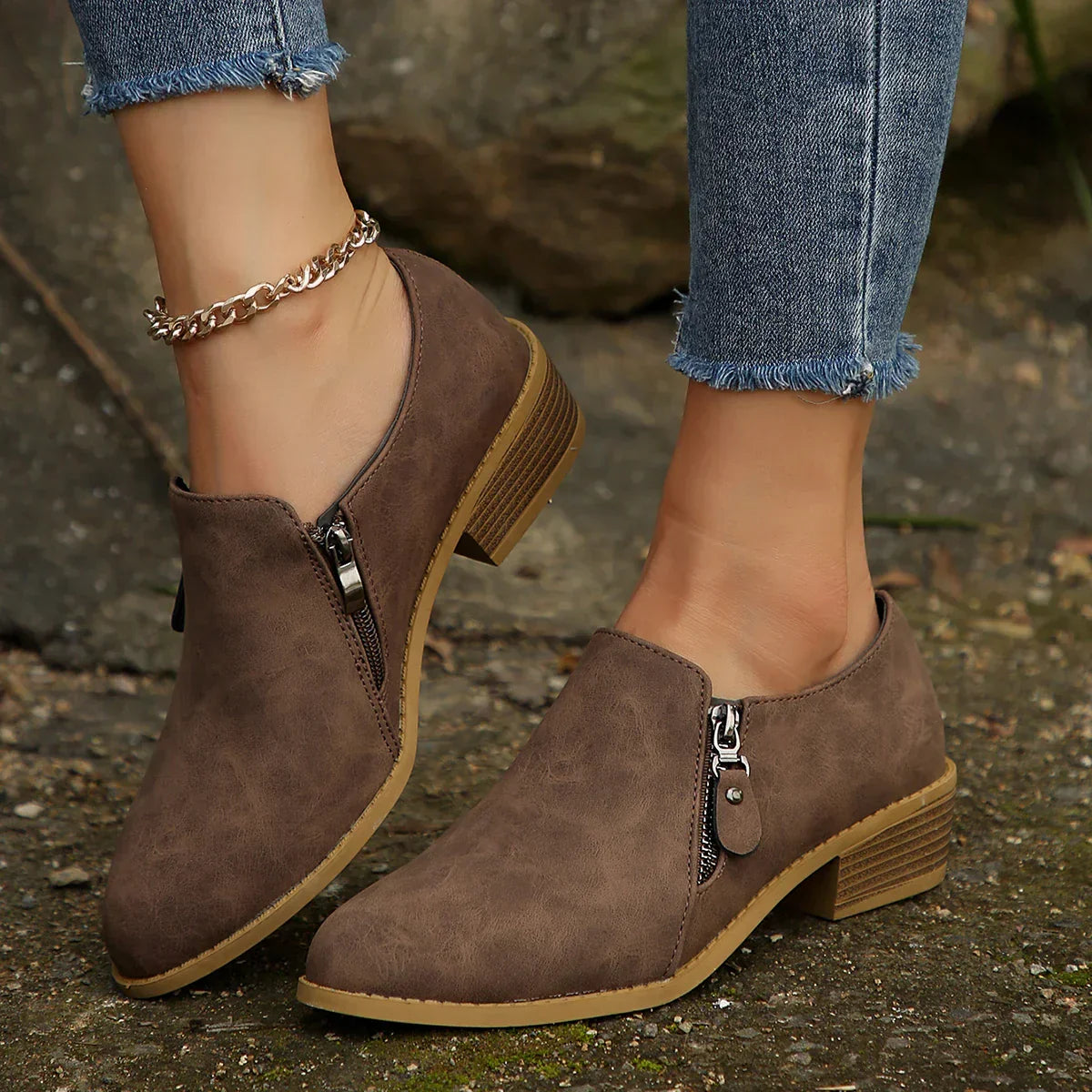 Black waterproof zip-up ankle boots with sleek streamlined silhouette and smooth SleekShield finish