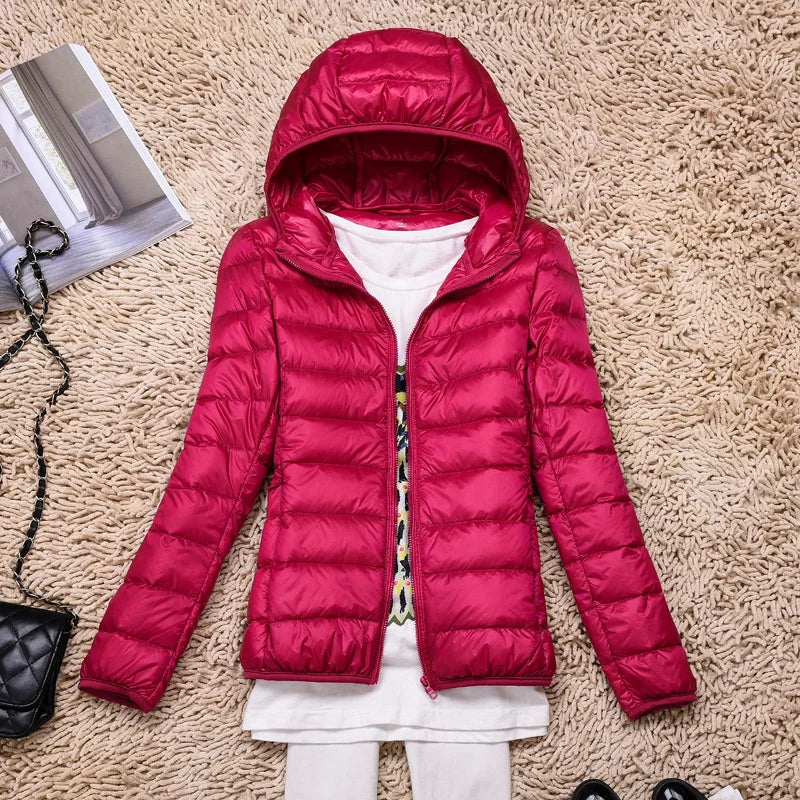 Women's quilted down jacket tailored hip-length fit with hood, lightweight warmth in neutral tone