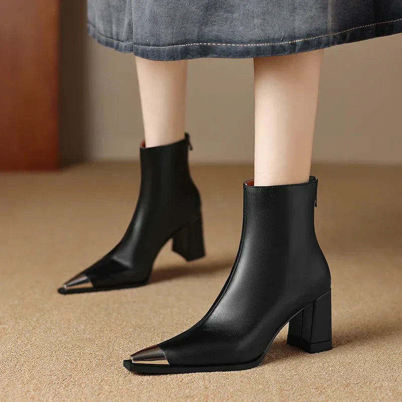 Black sleek ankle boots with streamlined silhouette and leg-lengthening elegant design