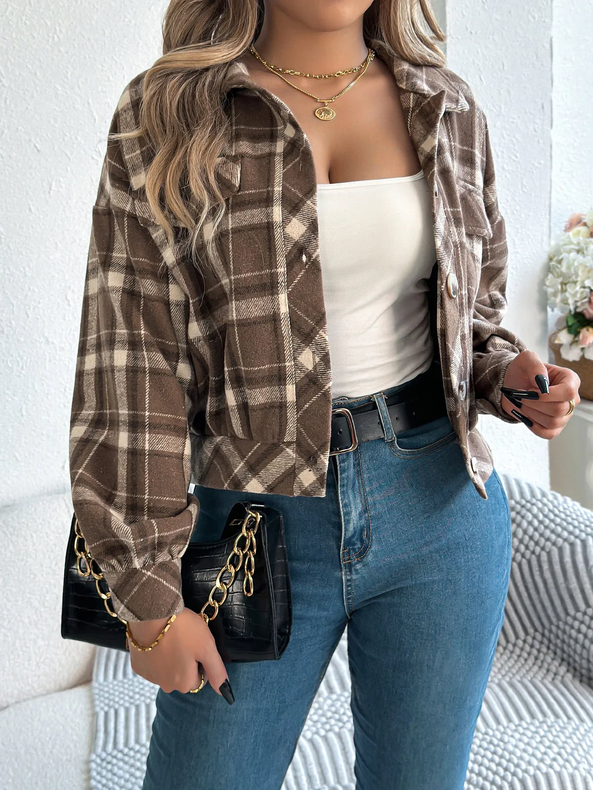 Cropped plaid jacket in warm tones with brushed fabric, draped sleeves, and faux horn buttons