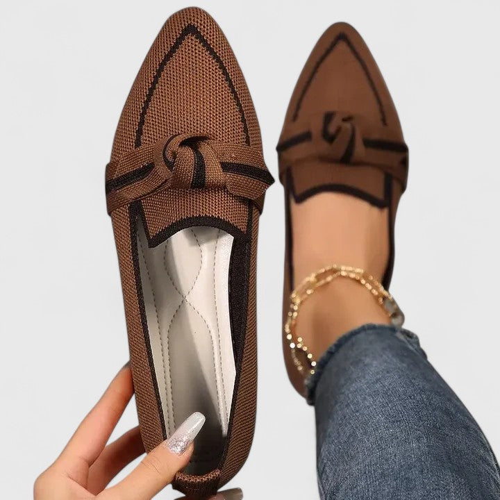 Women's pointed toe slip-on flat loafers in two-tone finish with elegant knot detail