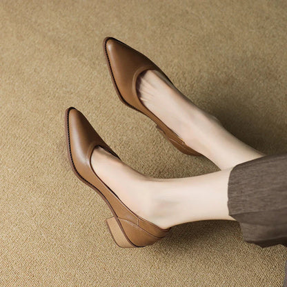 Women's black pointed toe block heel pumps with sleek slip-on design and stable mid-height heel