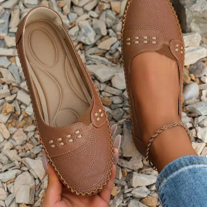 Women's beige PU leather slip-on loafers with cushioned insole and polished timeless silhouette