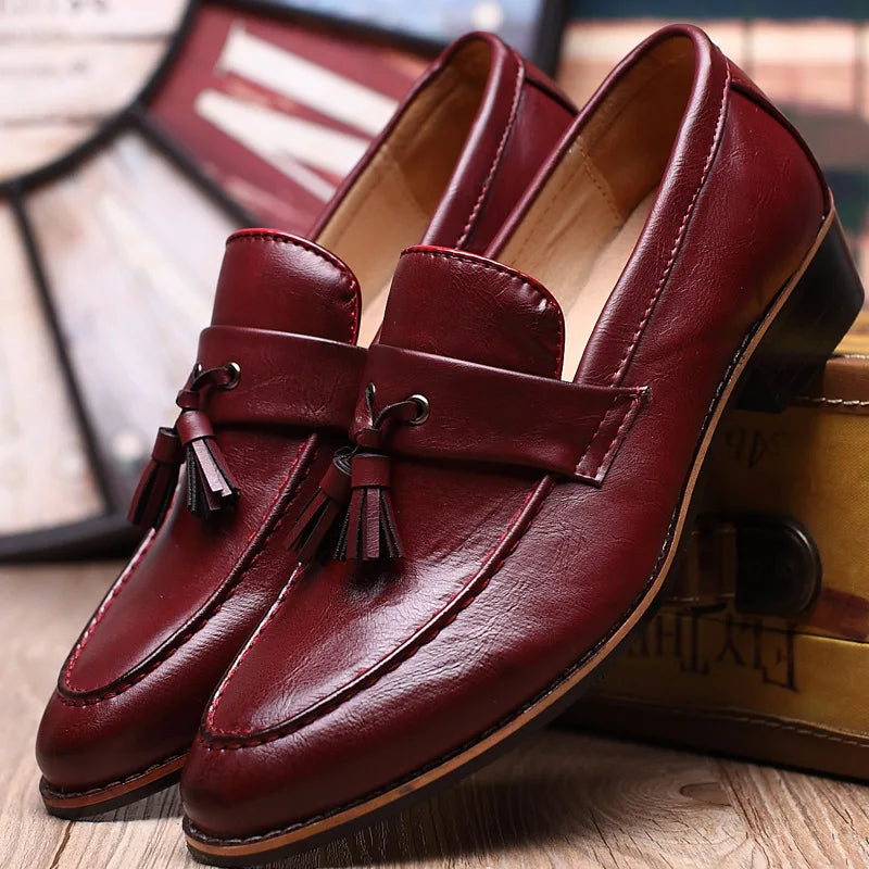 Brown leather loafers moccasin style with stitched toe detail and classic structured silhouette