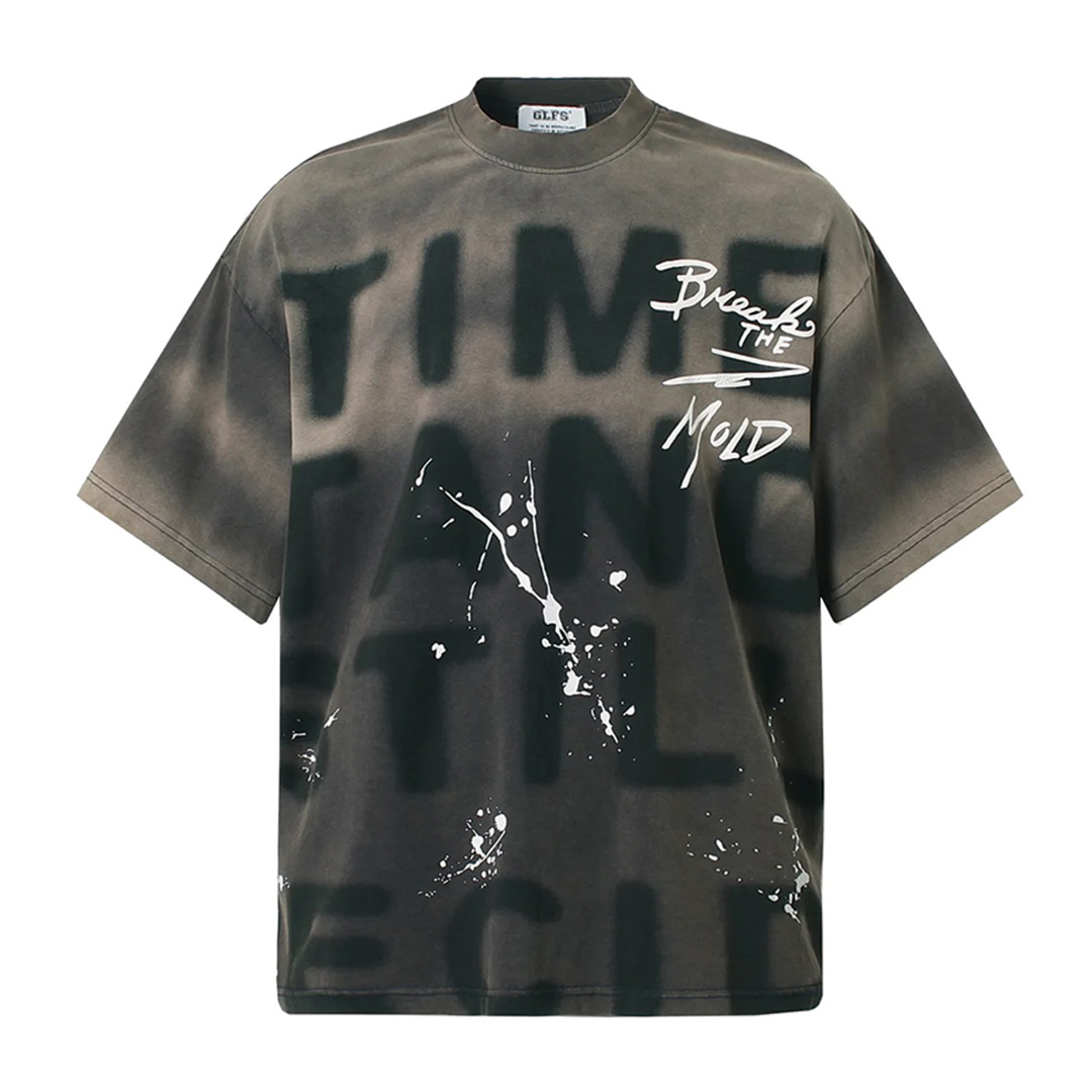 White loose fit graphic tee with bold paint-splatter print and garment-dyed soft-washed finish