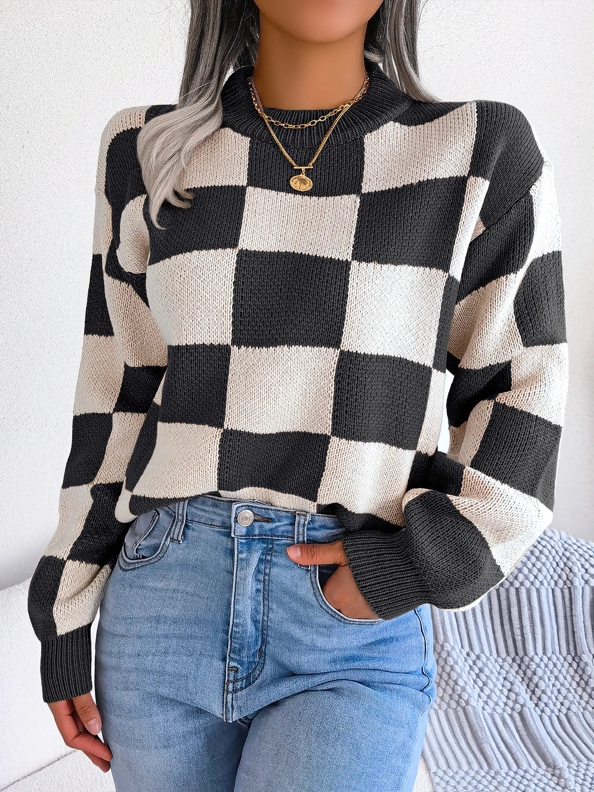 Relaxed checkered knit sweater in warm beige and ivory tones with retro-inspired bold pattern