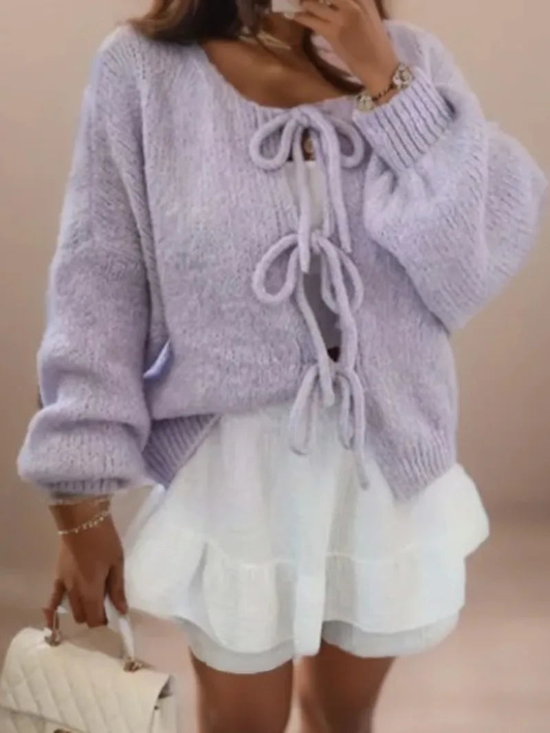 Women's chunky knit cardigan in cozy winter style featuring a distinctive knotted front tie closure
