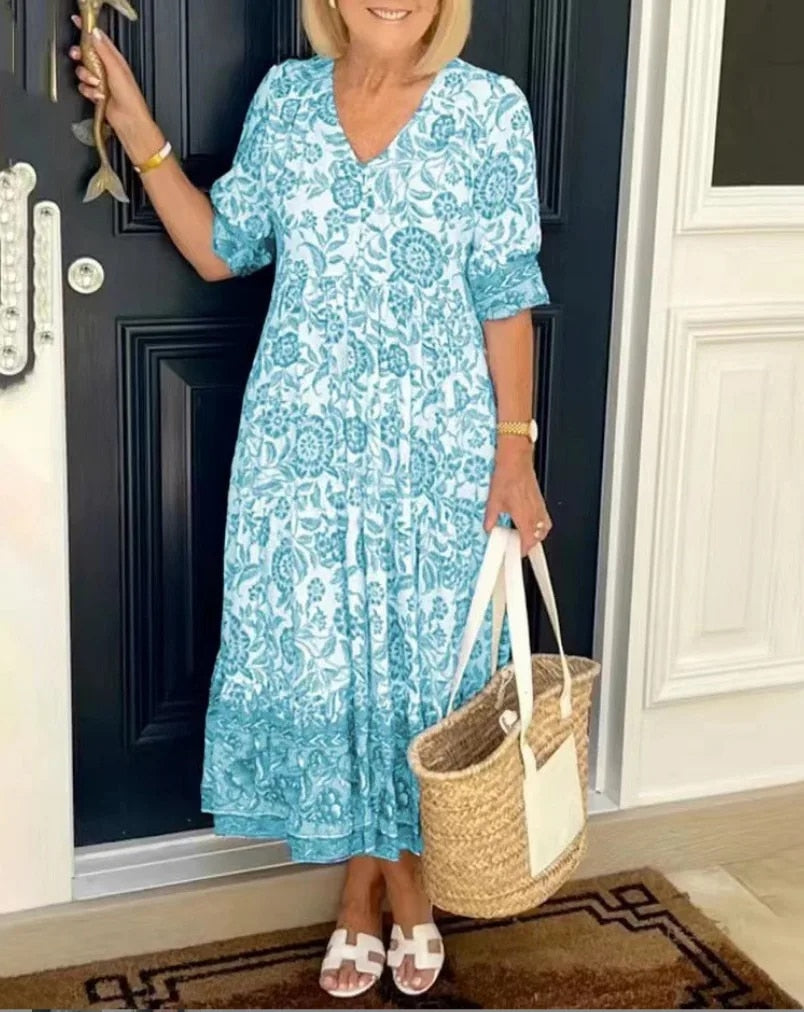 Elegant floral midi dress with V-neck, flowing silhouette, romantic spring print in soft feminine tones