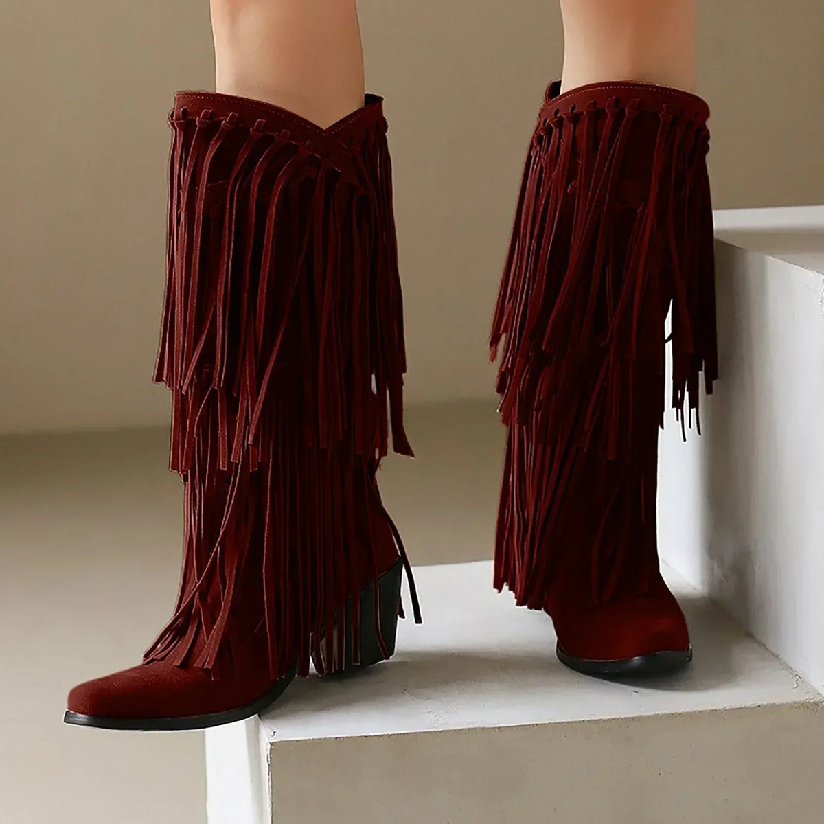 Women's brown fringe knee-high western boots with block heel and flowing fringe detailing