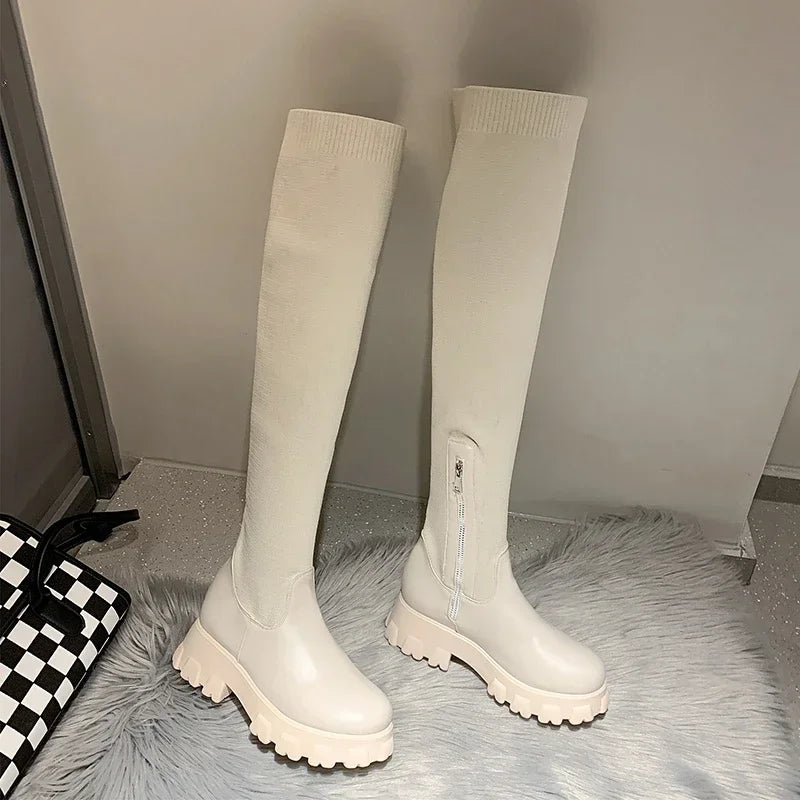 Women's black knee-high boots with sleek silhouette and bold chunky lug sole for street style