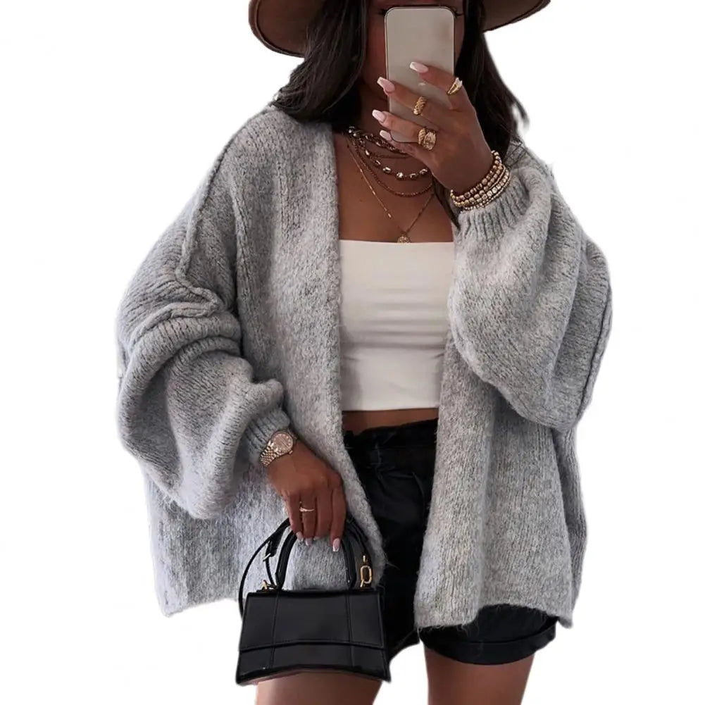 Beige oversized open-front cardigan with chunky knit texture and relaxed drape fit