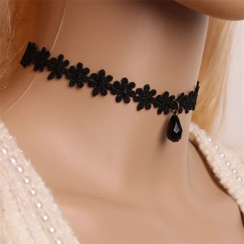 Gothic black velvet choker necklace with intricate lacework and bold pendant, adjustable closure
