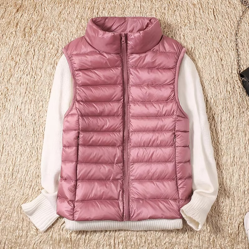 Women's cropped sleeveless light down puffer vest in neutral tone, slim-fit quilted design for layering