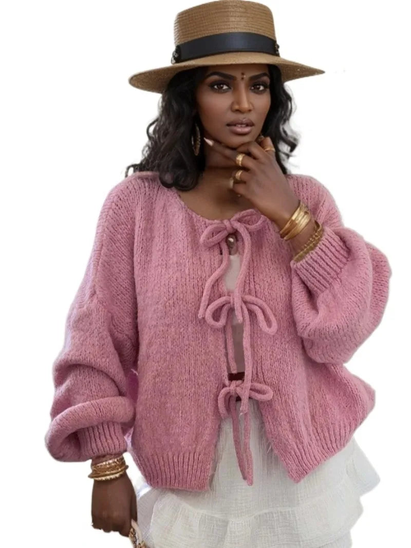 Women's chunky knit cardigan in cozy winter style featuring a knotted front tie detail
