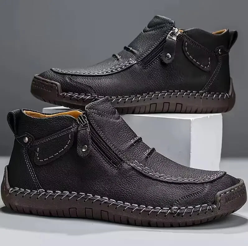 Men's brown leather boots with hand-stitched detailing, cushioned sole, and side zip closure