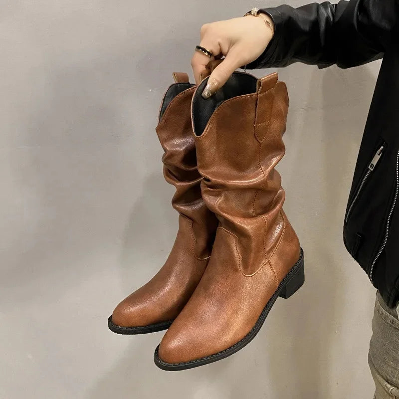 Women's brown leather knee-high slouch boots with low heel, relaxed shaft silhouette