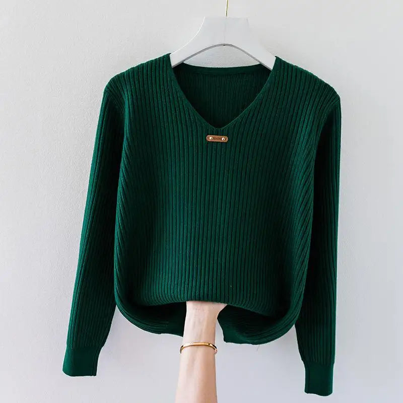 Ivory slim-fit ribbed knit pullover top with V-neckline and metal collar charm detail