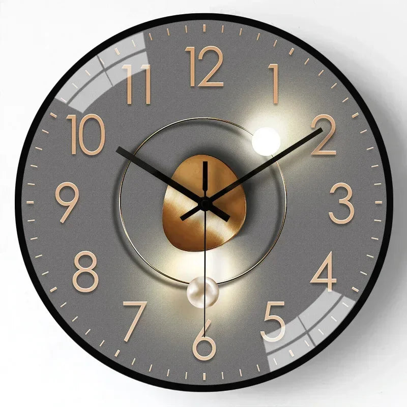 Golden tone modern wall clock with minimalist hour markers and elegant circular metal frame design
