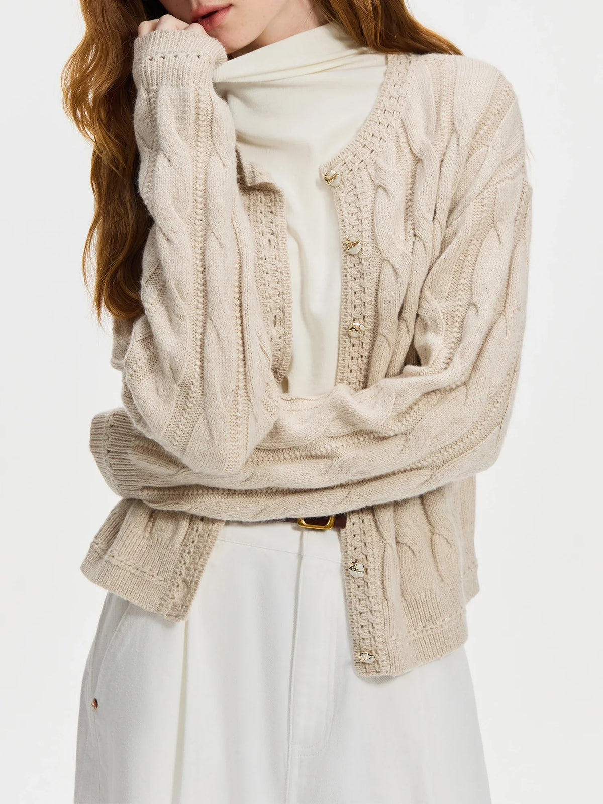 Cream cable knit cardigan sweater with gold pearl buttons, soft wool blend, vintage-inspired style