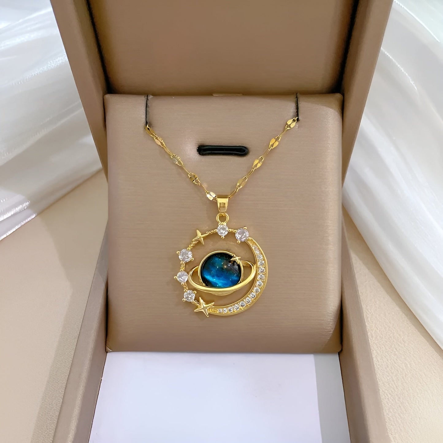 Gold-plated celestial necklace with aquamarine gemstone and dainty crystal accents on cable chain
