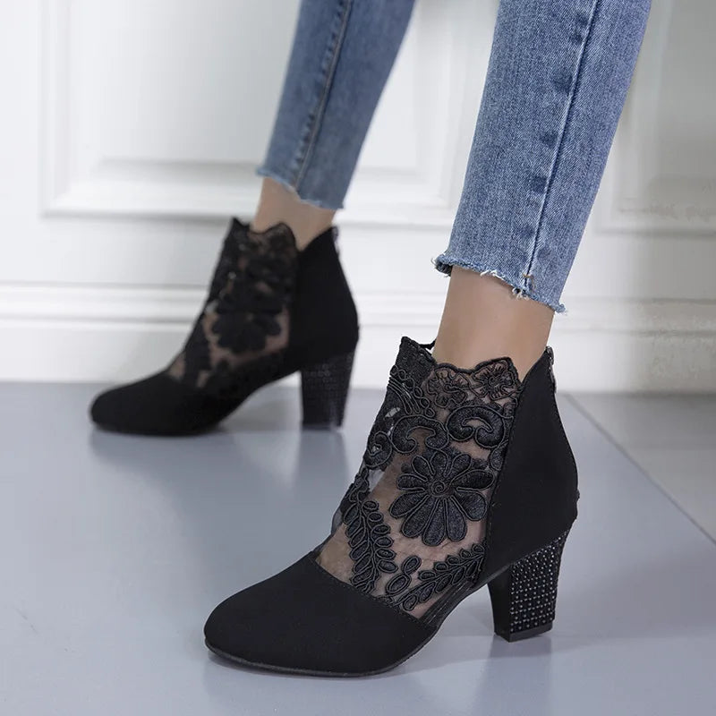 Elegant black lace mesh high heel boots with sleek silhouette and leg-lengthening stiletto design